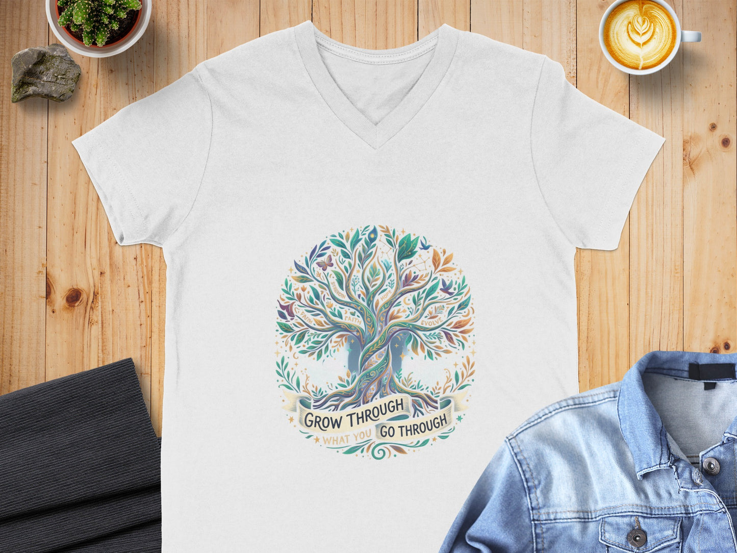 White v-neck t-shirt with a colorful tree of life design and text.