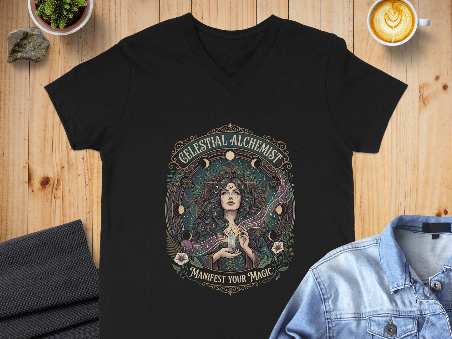 Black v-neck t-shirt with "Celestial Alchemist Manifest Your Magic" graphic.
