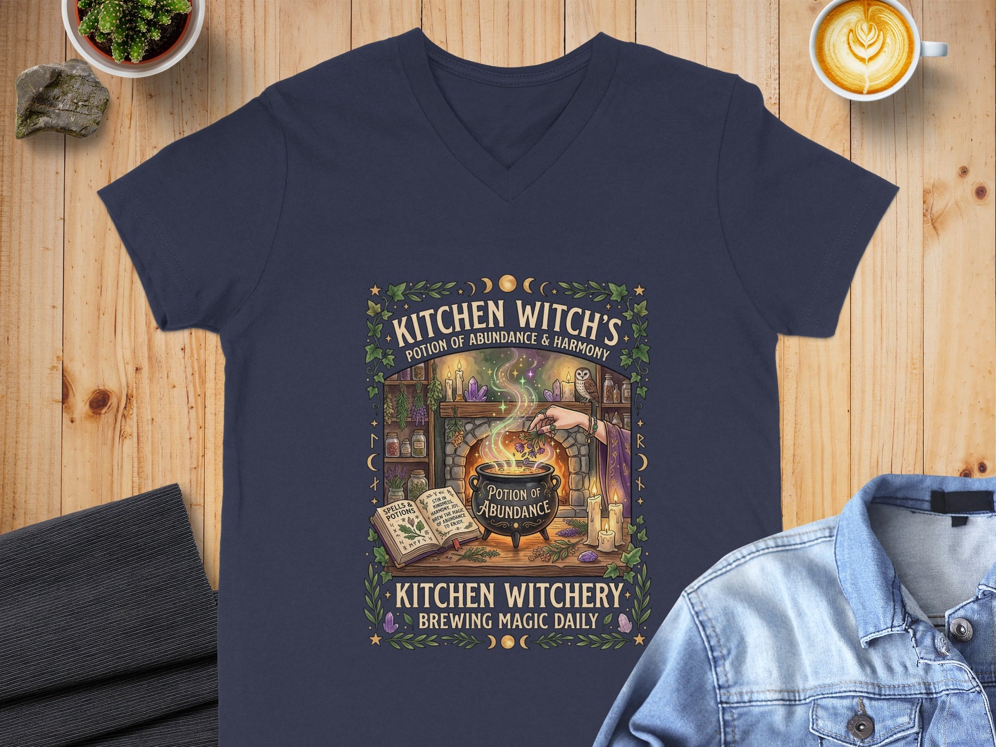 T-shirt with "Kitchen Witch's Potion of Abundance" illustration and text.