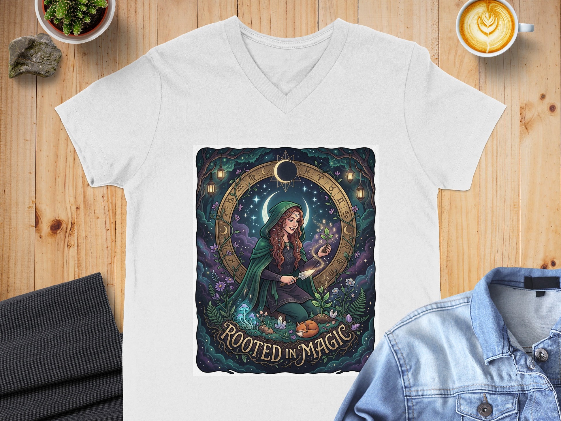 White v-neck t-shirt with "Rooted in Magic" moon and zodiac design.