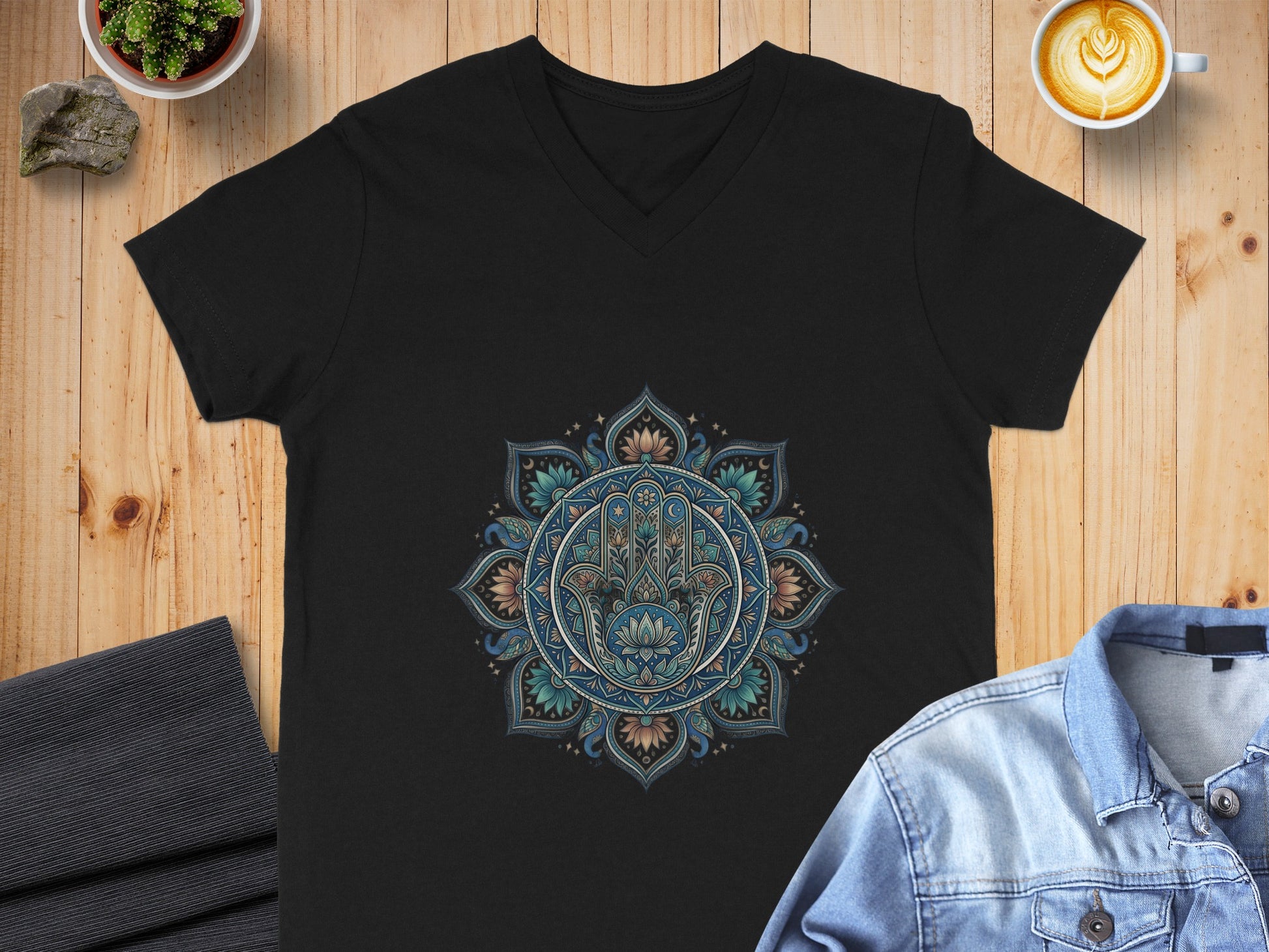 Black v-neck t-shirt with Hamsa Hand mandala graphic.