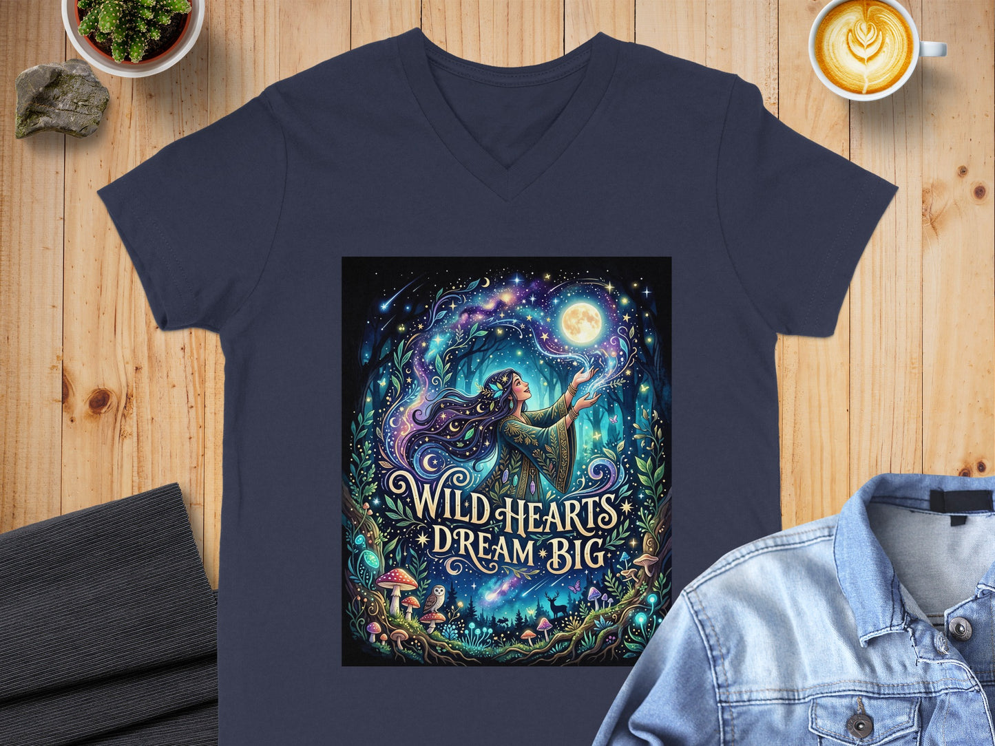 Navy t-shirt with celestial forest design and "Wild Hearts Dream Big" text.