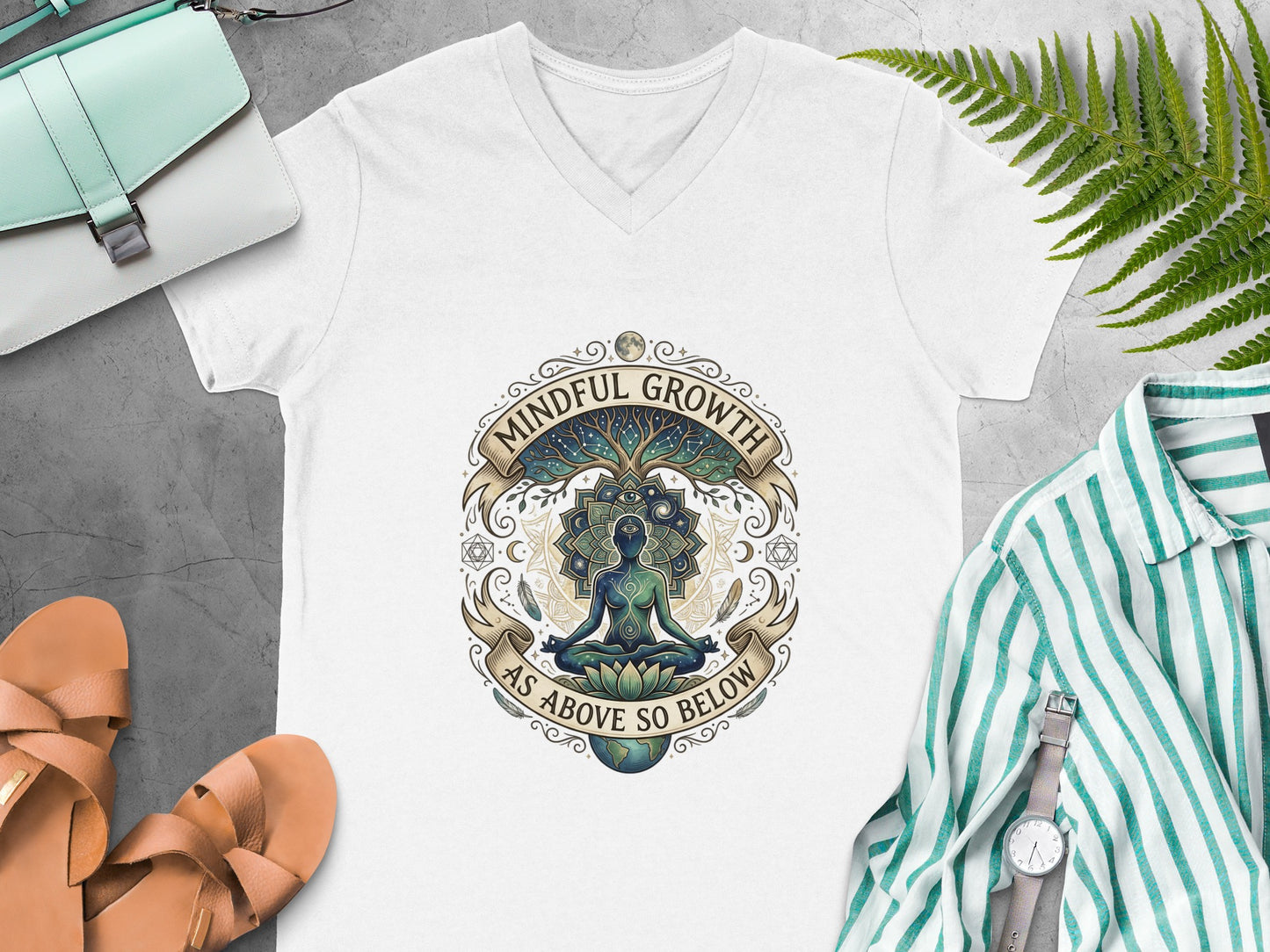 V-neck t-shirt with "Mindful Growth As Above So Below" and meditating figure design.