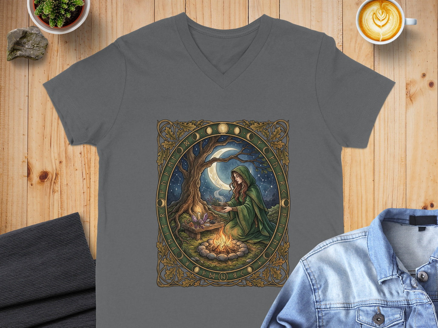 Gray v-neck t-shirt featuring a woman in a green cloak by a campfire under a full moon.