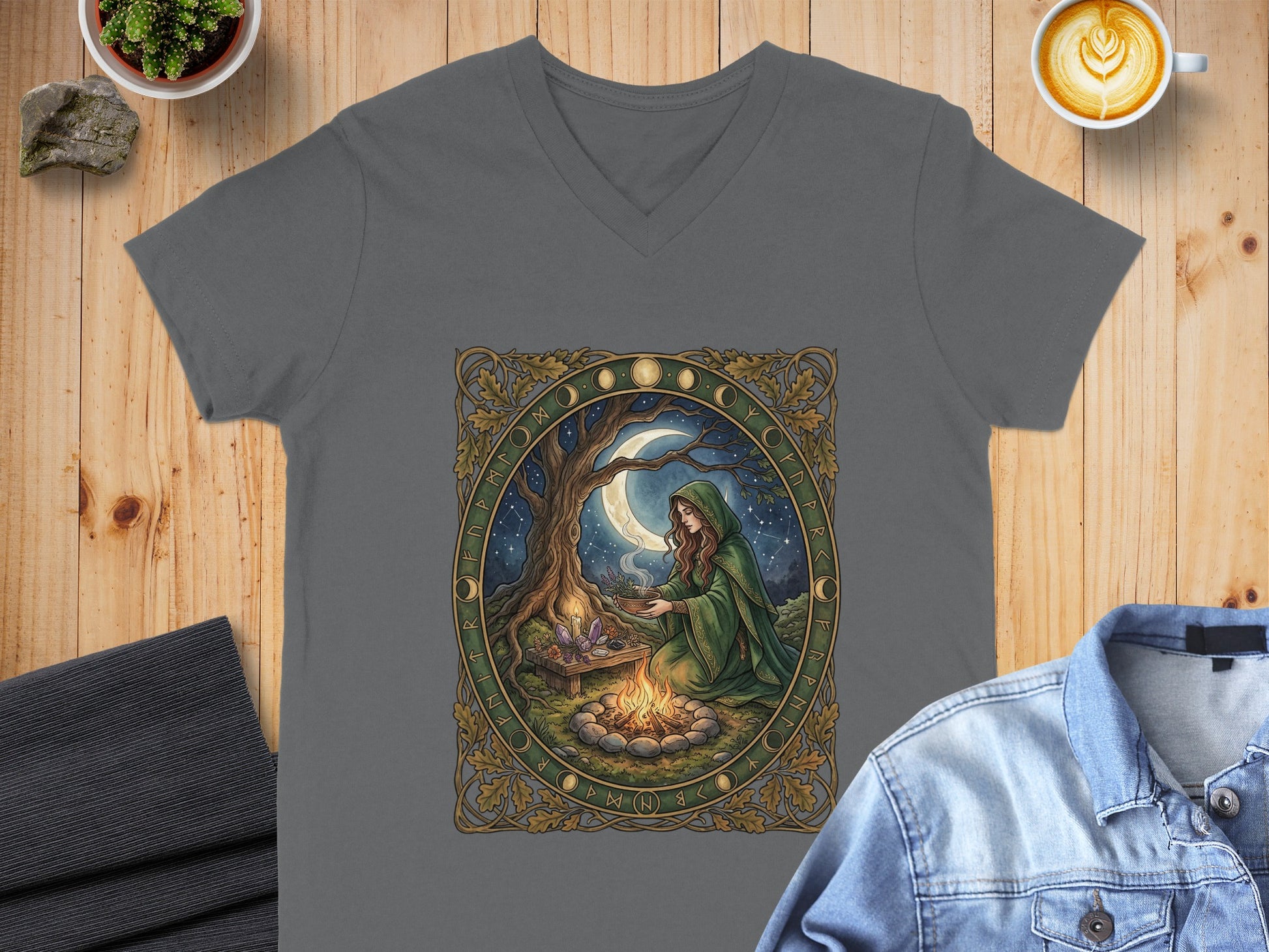 Gray v-neck t-shirt featuring a woman in a green cloak by a campfire under a full moon.