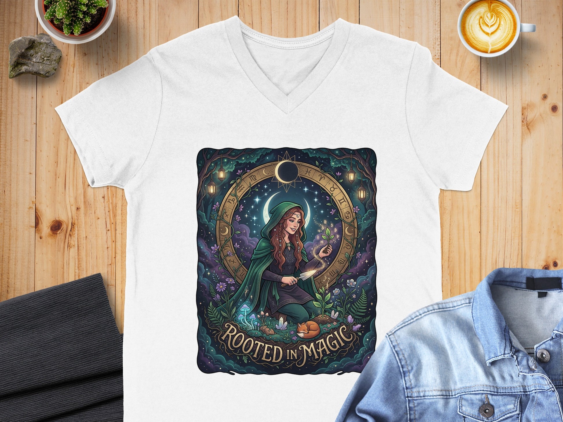 T-shirt featuring a woman in a green cloak surrounded by zodiac symbols and text.