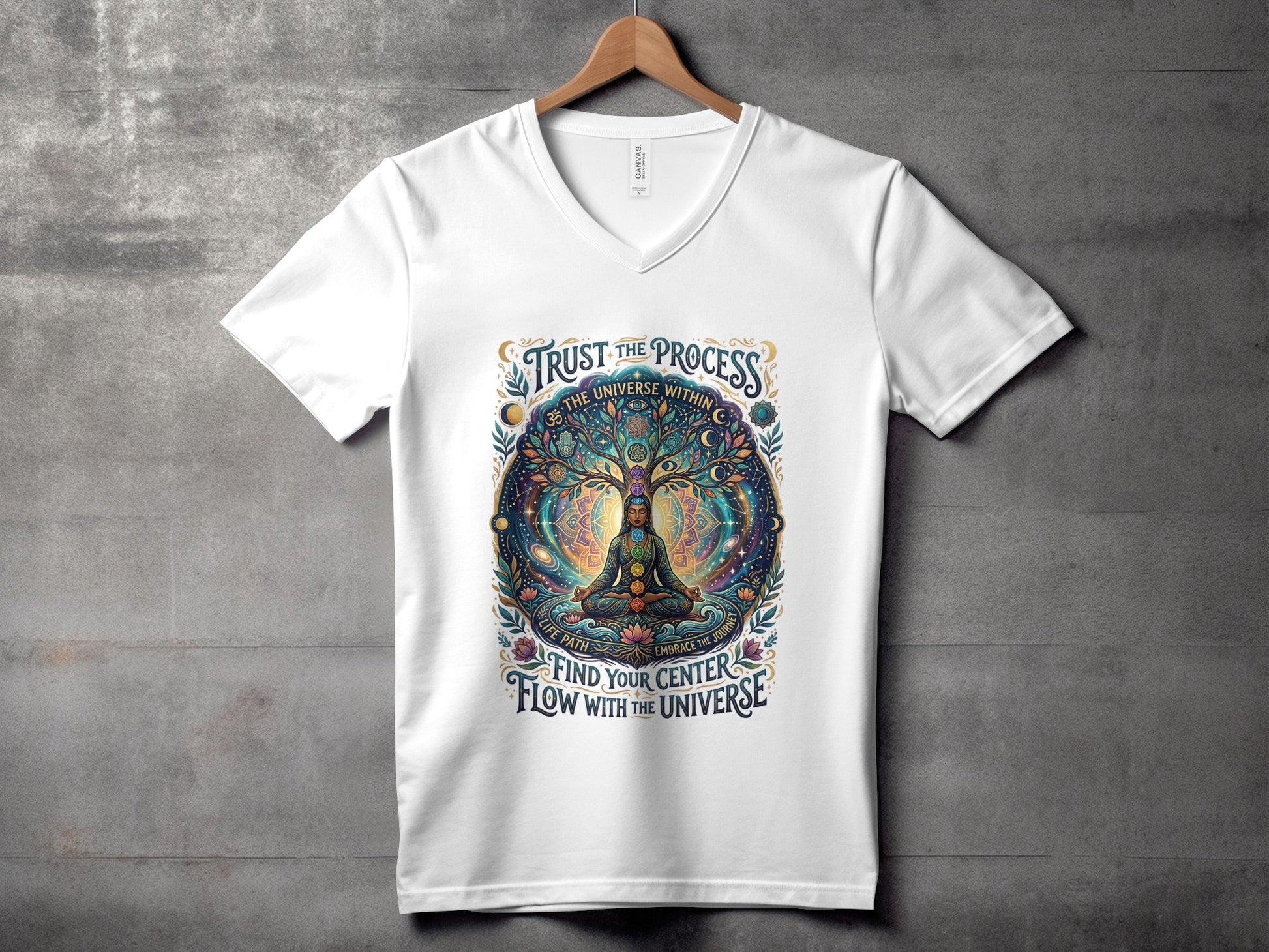White v-neck t-shirt with colorful cosmic tree and meditating figure.
