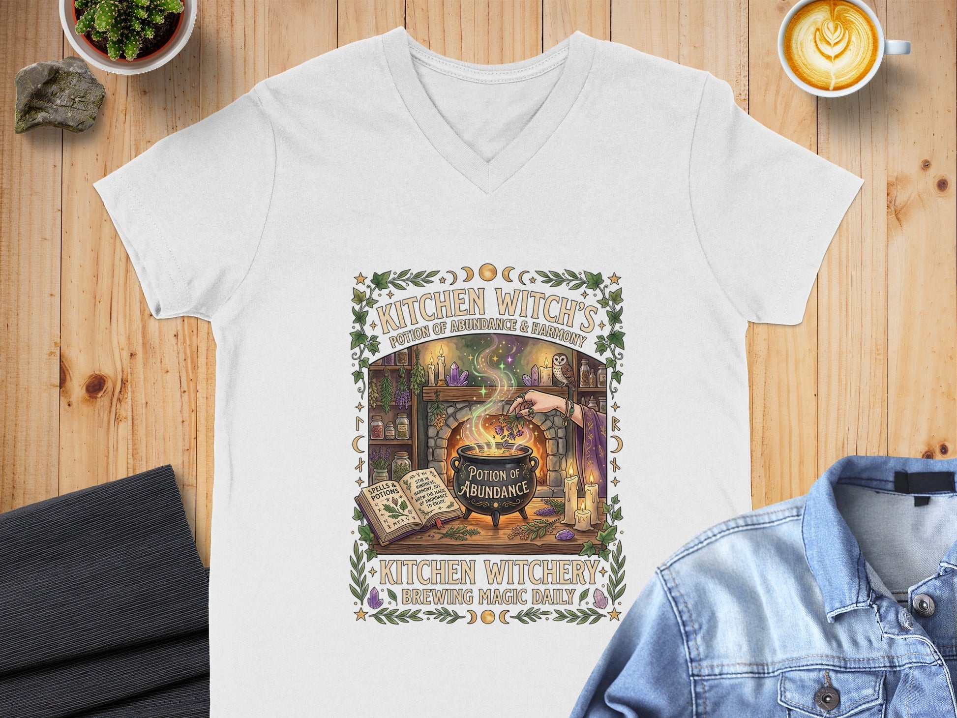 White v-neck t-shirt with "Kitchen Witch's Potion of Abundance" design.