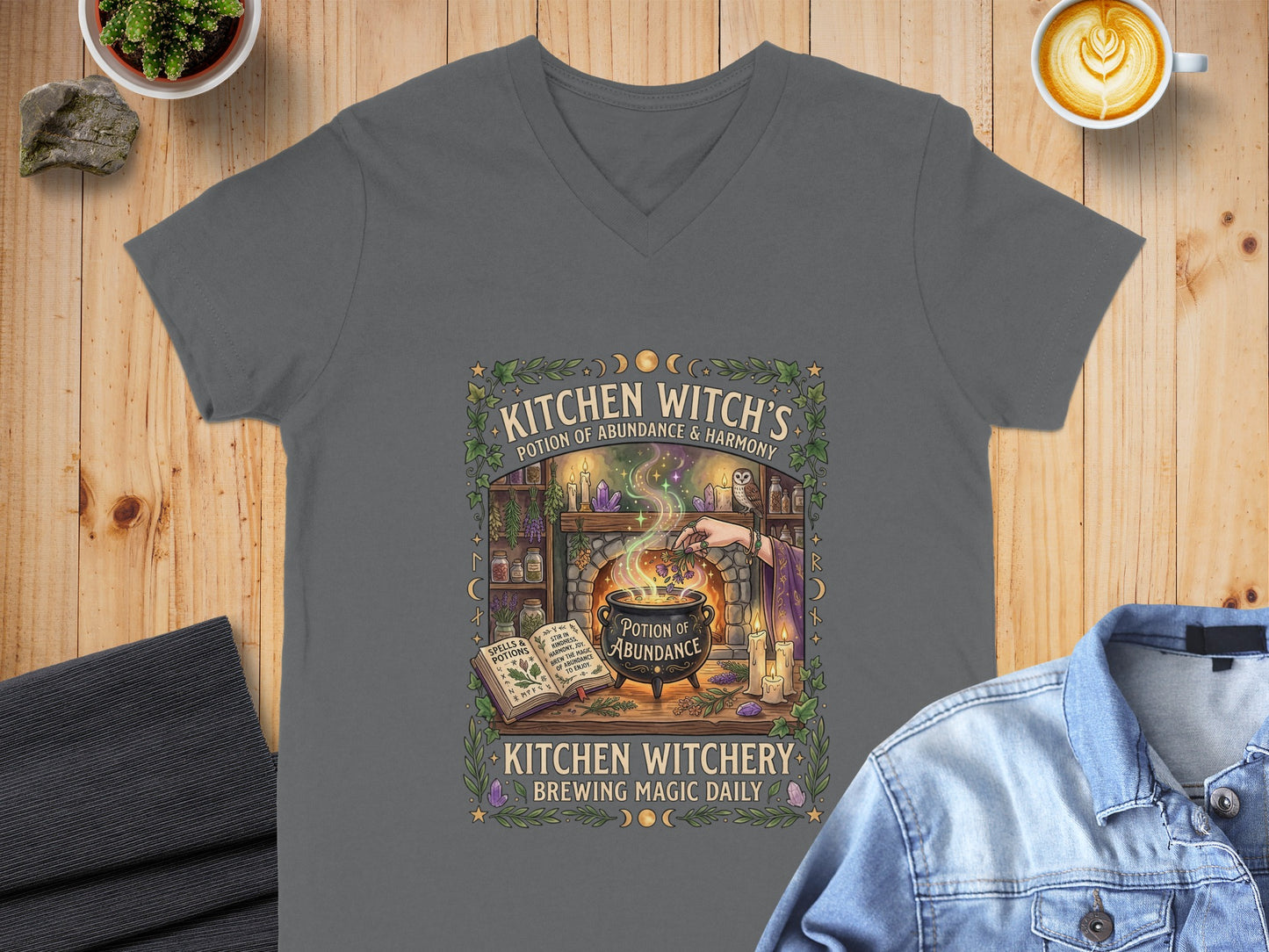 T-shirt with "Kitchen Witch's Potion of Abundance & Harmony" design.