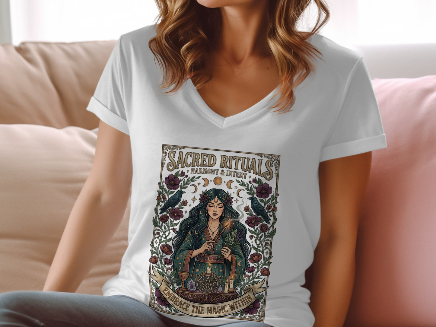Woman wearing white t-shirt with "Sacred Rituals" graphic.
