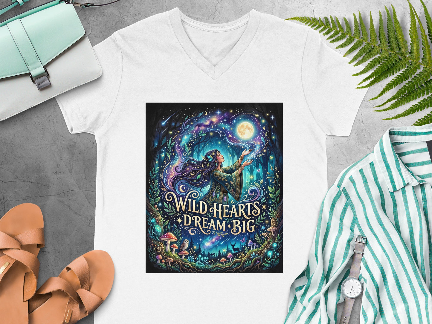 White v-neck t-shirt with "Wild Hearts Dream Big" celestial forest graphic.
