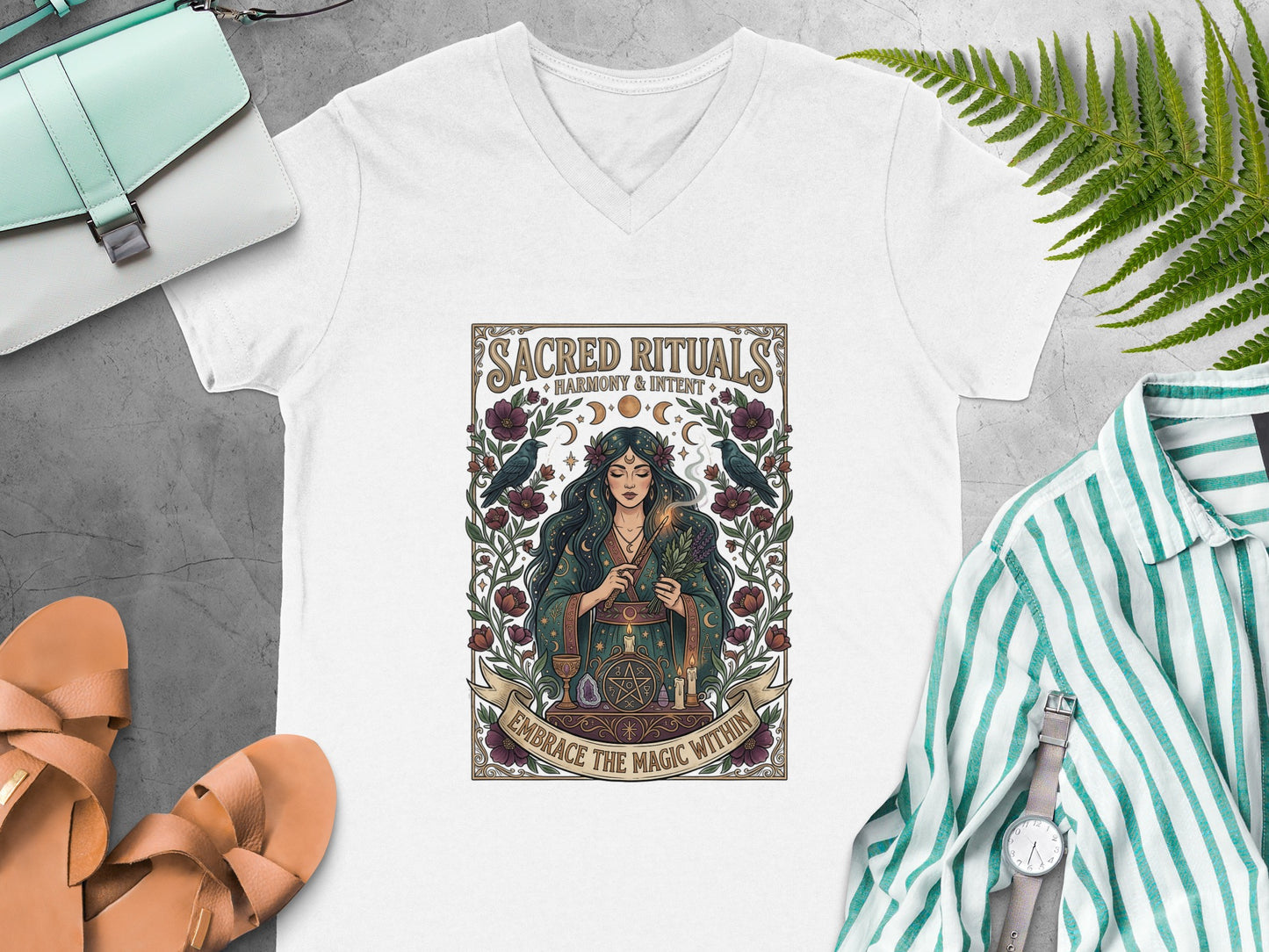 T-shirt graphic with woman, celestial elements, and text "Sacred Rituals Harmony & Intent Embrace the Magic Within."